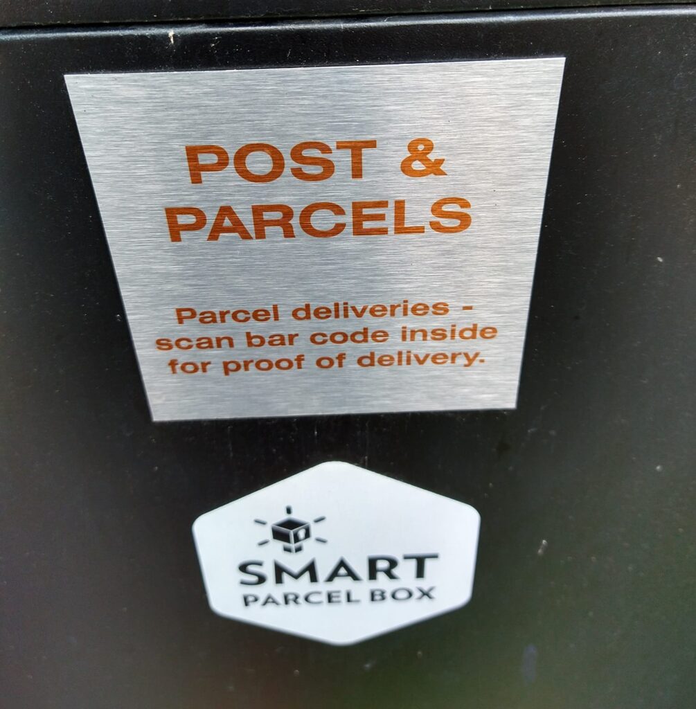 Medium Front Access Black Smart Parcel Box with instructions sticker.